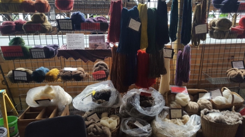 Wool yarn, roving, and fleece display at fair